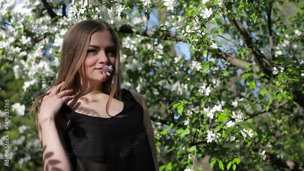 A beautiful girl in a blooming garden. Close-up A beautiful girl in a blooming garden. Close-up
