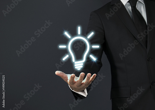Businessman magical touch concept - idea bulb