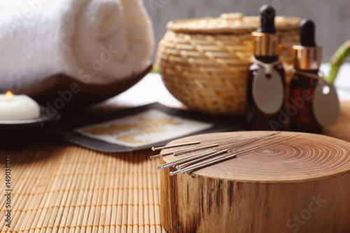 Composition with acupuncture needles on bamboo mat