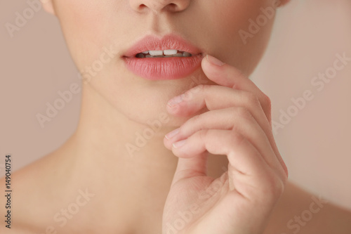 Beautiful young woman on blurred background  closeup