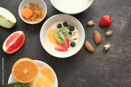 Composition with tasty yogurt and different products on table