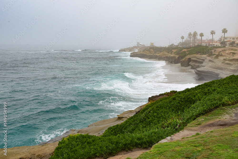 Fog hugs the coastline in La Jolla, California near San Diego.