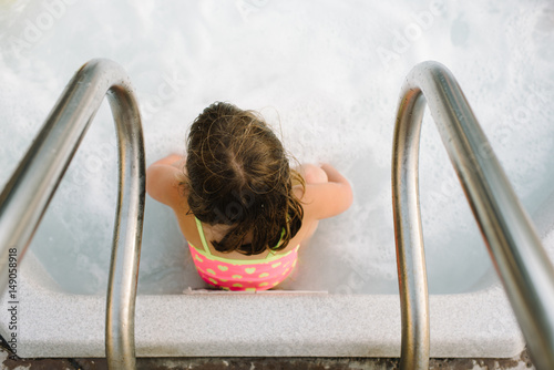 Girl sitting in hot tub photo