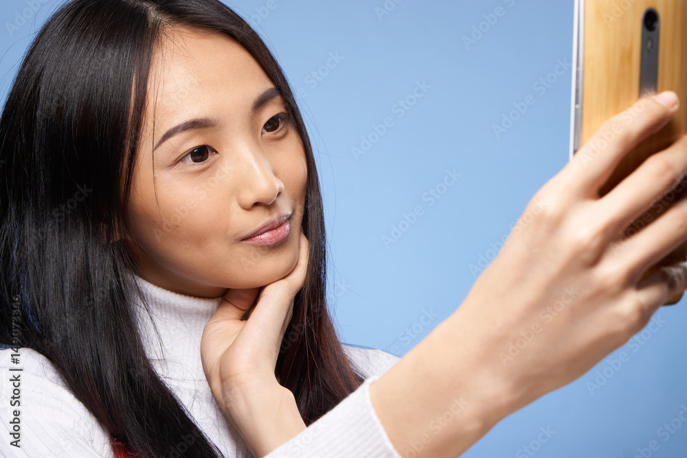 woman, selfie on a blue background woman, selfie on a blue background