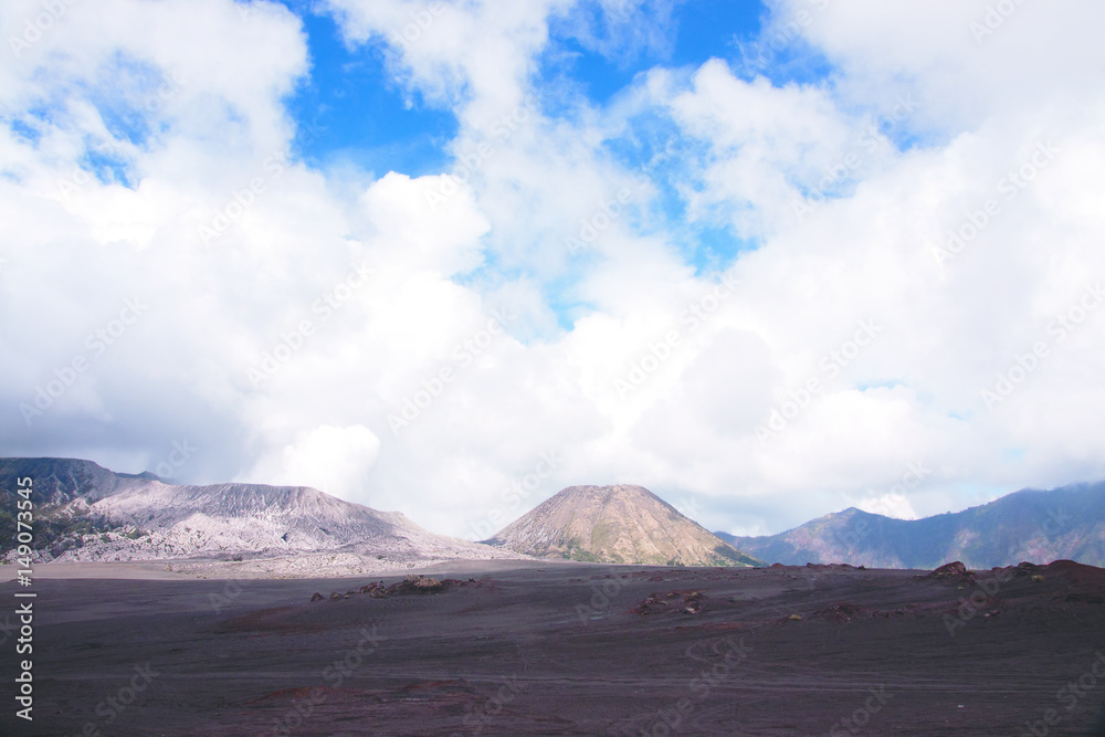 Panorama view at the sandy foot of the active Volcano mount Bromo early in the morning at the Tengger Semeru National Park in East Java, Indonesia.