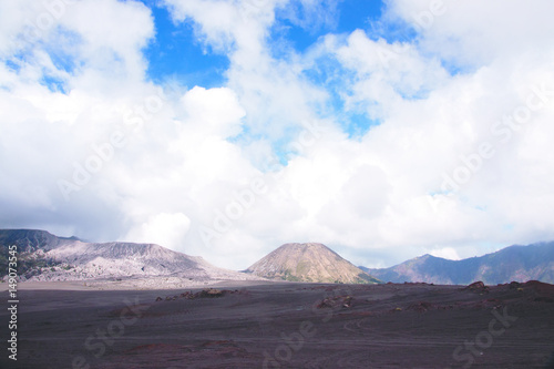 Panorama view at the sandy foot of the active Volcano mount Bromo early in the morning at the Tengger Semeru National Park in East Java  Indonesia.