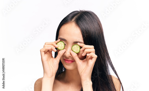young woman closes her eyes cucumber slices, diet