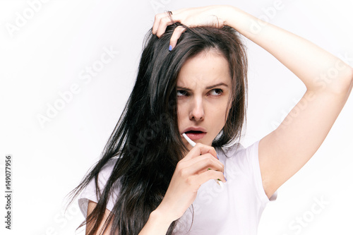 emotional woman brushing her teeth against a light background