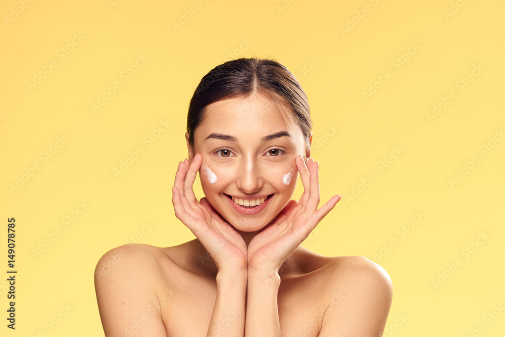 woman, white cream, yellow background, moisturizing woman, white cream, yellow background, moisturizing