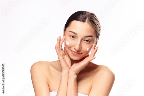 happy woman with cream on a beautiful face