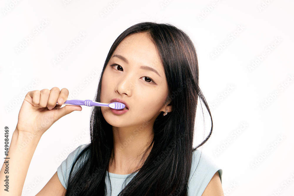 young woman with a purple toothbrush, oral care young woman with a purple toothbrush, oral care