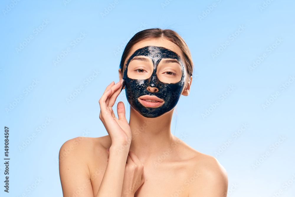 Fototapeta premium beautiful woman with a black mask on her face