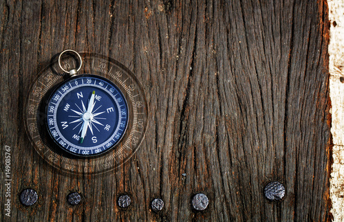 compass on old wood background, flat top view, find the right path concept