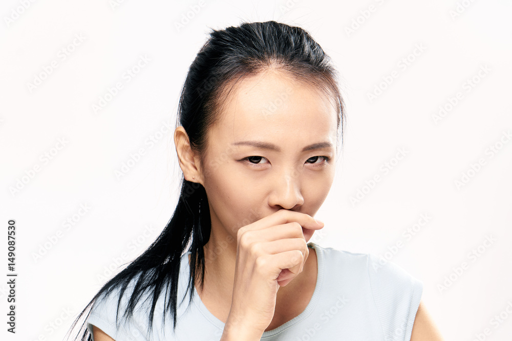 a young woman covered her mouth with her hand a young woman covered her mouth with her hand