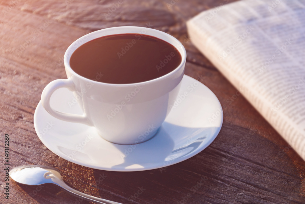 coffee cup clock and news paper on old wooden table coffee cup clock and news paper on old wooden table
