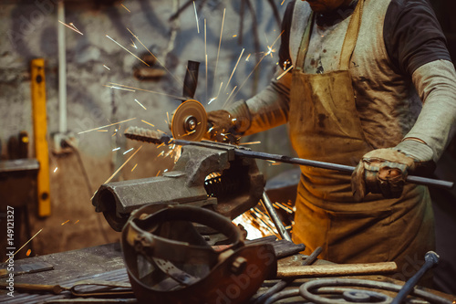 worker sawing the iron