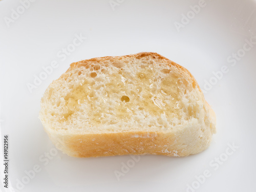 Piece of french bread with honey