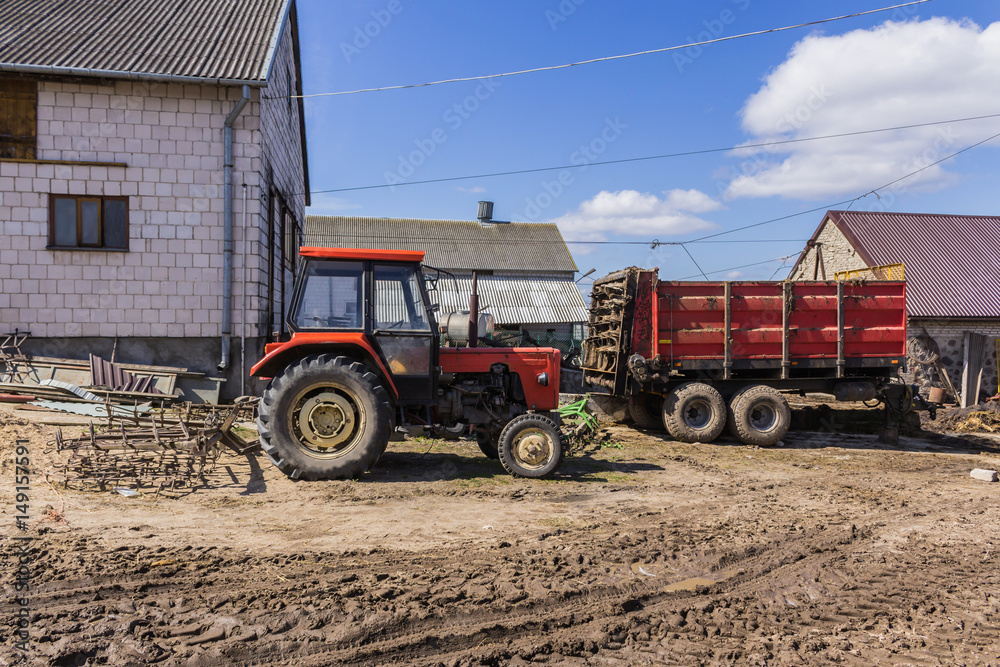Agricultural machinery and equipment . Tractor with a harrow for cultivating plowed land. The yard of a dairy farm. Podlaskie, Poland.