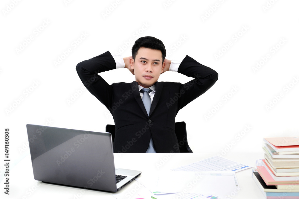 Young asian business man thinking of his plans at office with laptop on office desk Young asian business man thinking of his plans at office with laptop on office desk