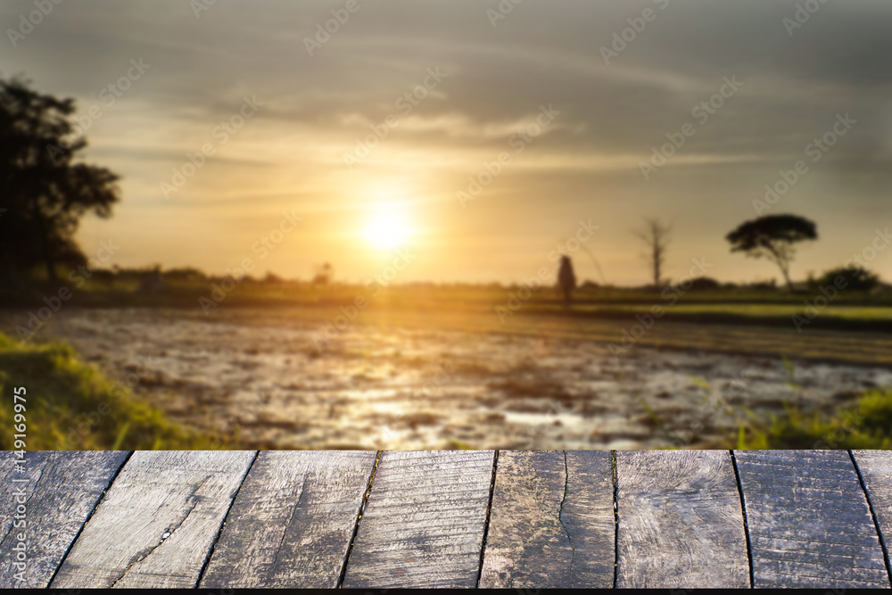 Empty of wooden desk space platform and empty Agriculture field and sunset vintage tone.