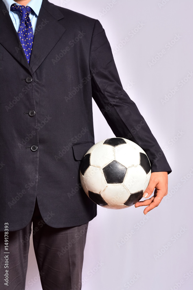 Businessman holding football ball Businessman holding football ball