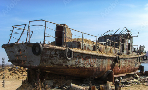 An old broken rusty ship on land