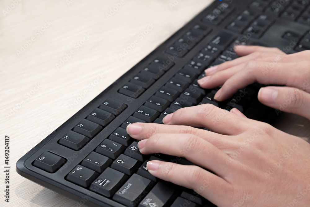 Hands typing keyboard. Focus on the left hand. Hands typing keyboard. Focus on the left hand.