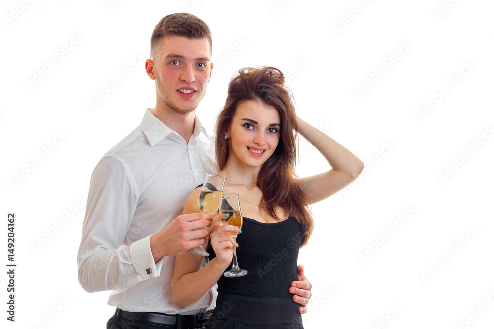young smiling guy with girl, look right and carrying champagne glasses young smiling guy with girl, look right and carrying champagne glasses
