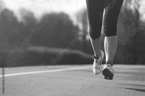 running, jogging or walking in park, feet closeup