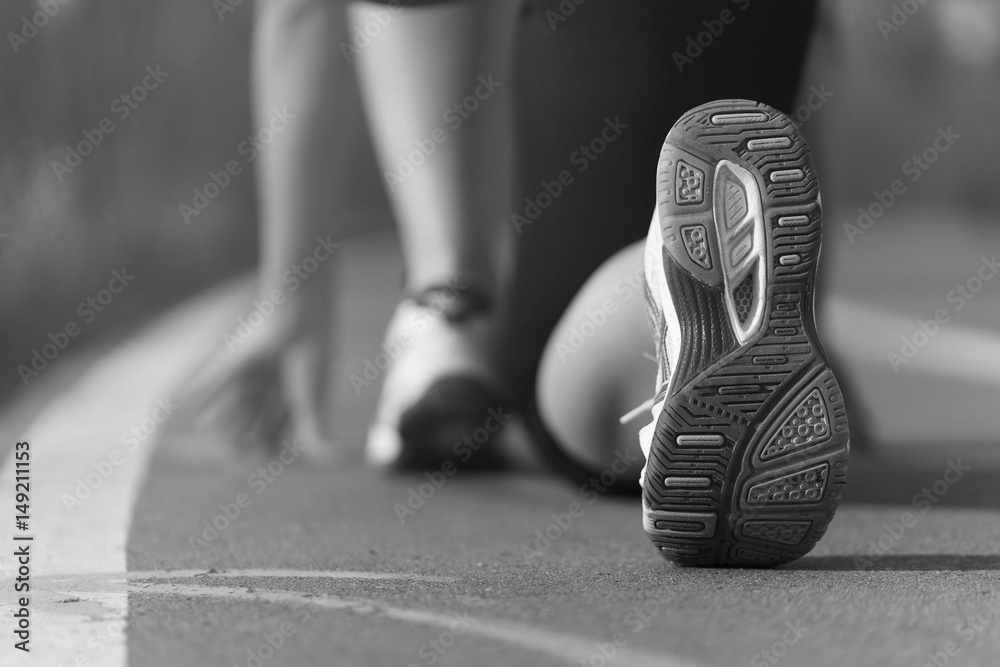 Athlete runner feet running in the Park on the track closeup on shoe