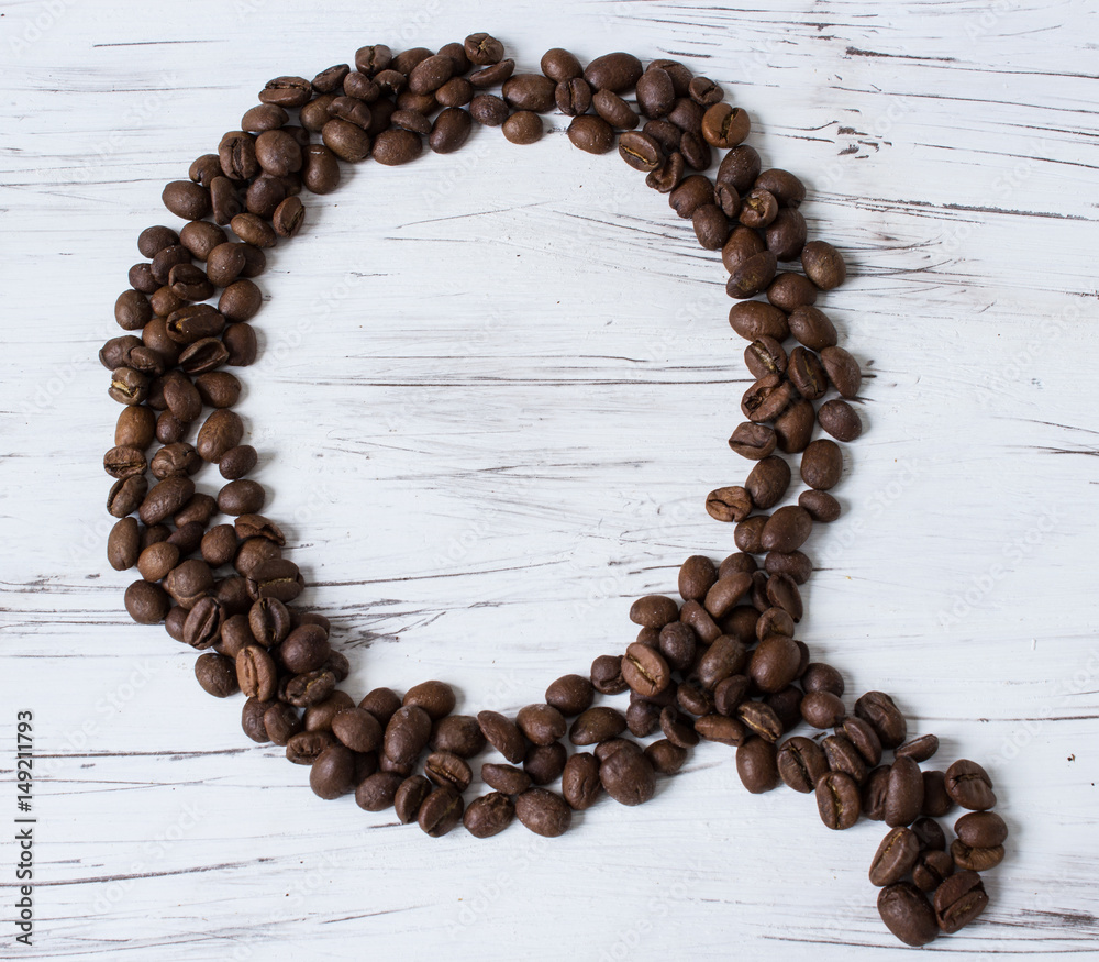 .Q letter of the English alphabet made of coffee beans. Light, old wooden background. Selective focus.. .Q letter of the English alphabet made of coffee beans. Light, old wooden background. Selective focus..