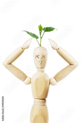 Man with growing from his head plant. Abstract image with a wooden puppet