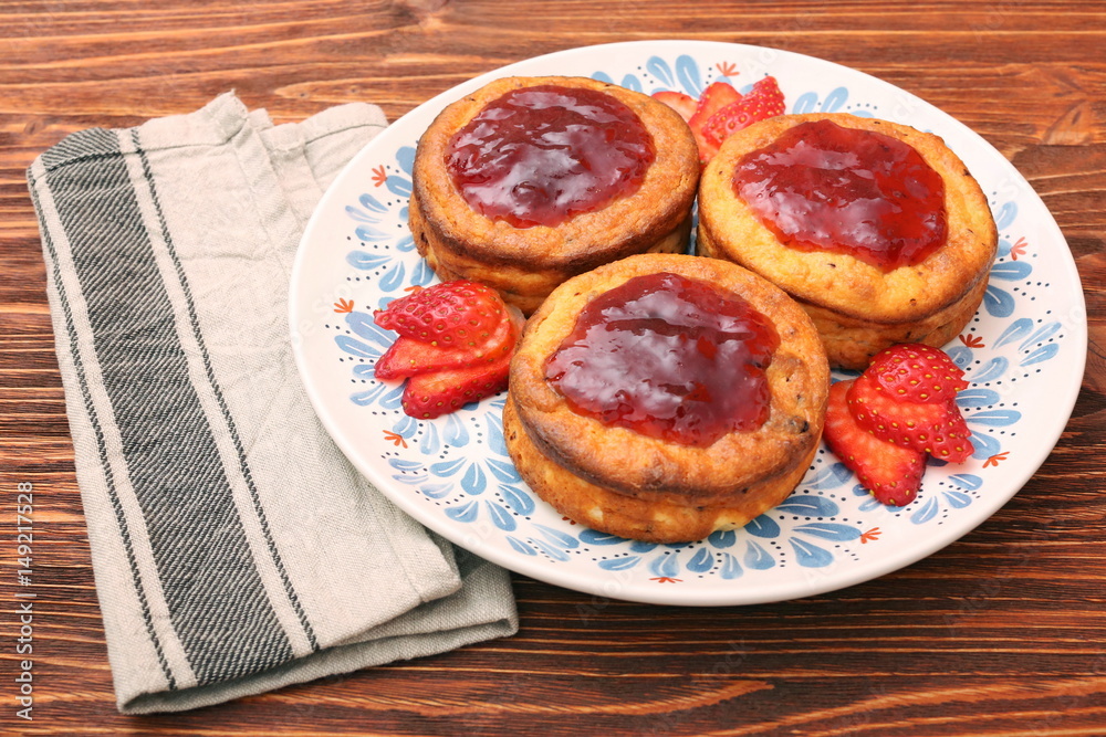 Cottage cheese patties with strawberry jam.