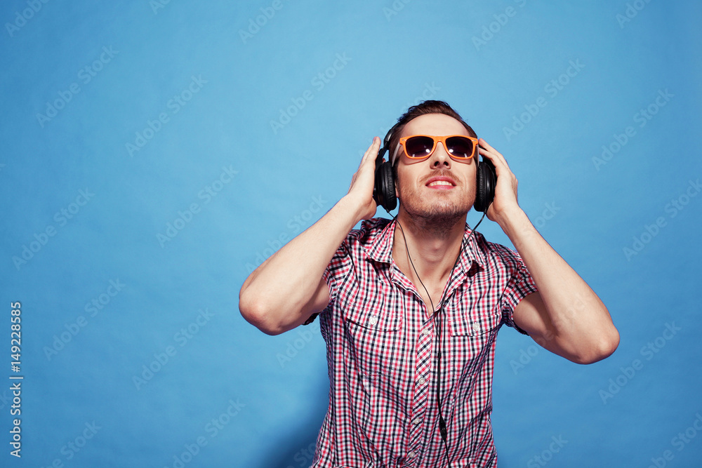 the guy with glasses and headphones on blue background the guy with glasses and headphones on blue background