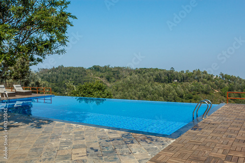 Swimming pool on top of a hill station with mountain in the background, tamilnadu, India, April 29 2017