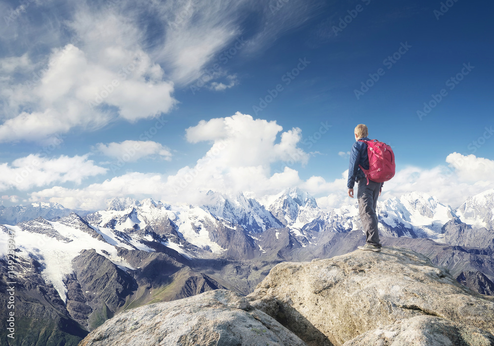 Tourist on the mountain range in the clouds. Active life concept