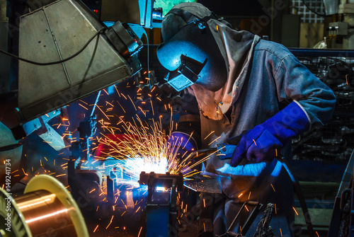 Worker,welding in a car factory with sparks, manufacturing, industry
