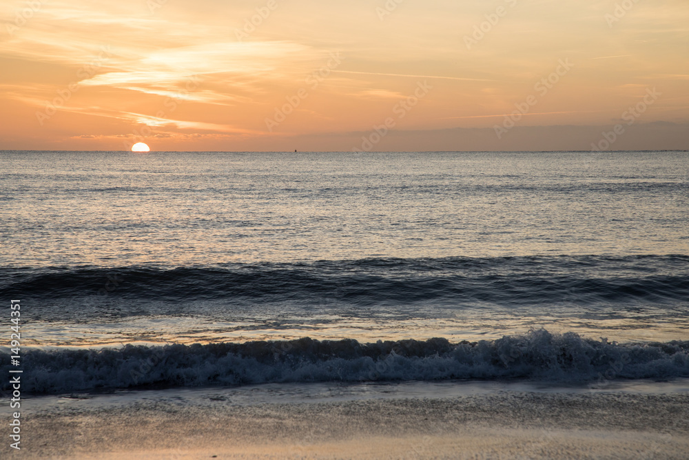 sun rising over horizon on beach