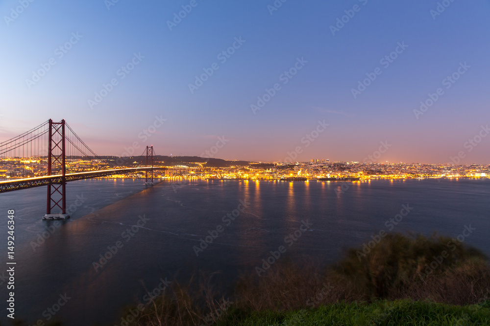 Sunset over the '25 of April' Bridge in Lisbon, Portugal.