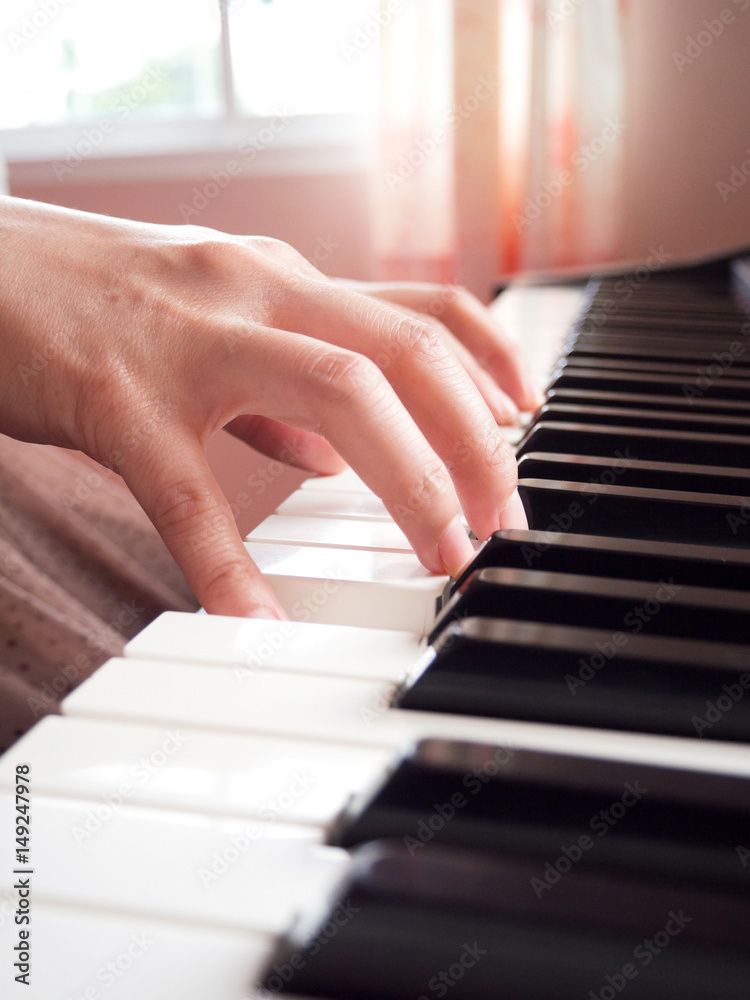 Woman hands playing piano. Music and art background.