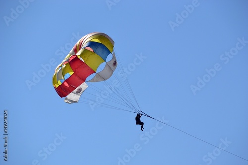 Bright parachute against the blue sky