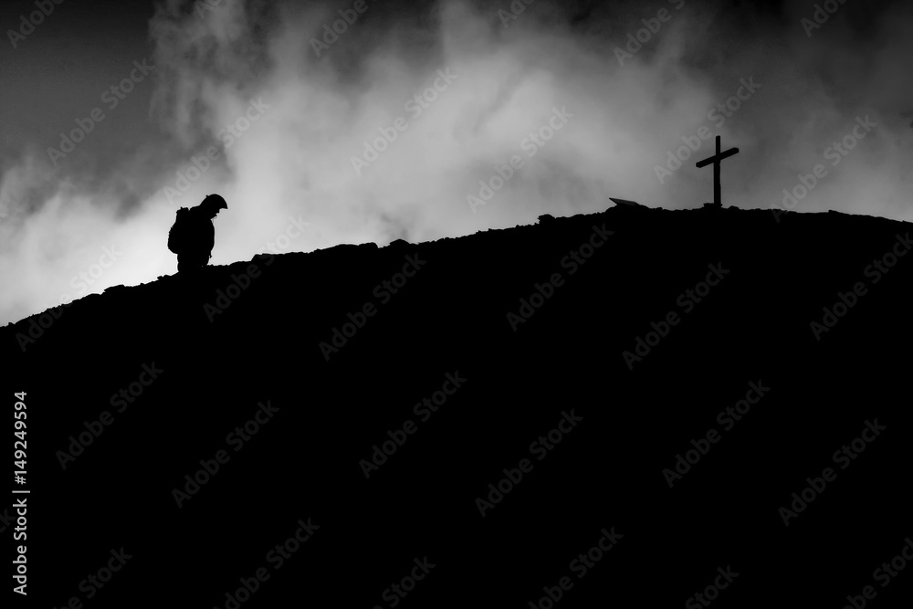 Lonely walker on the top of the mountain. Walking to the cross