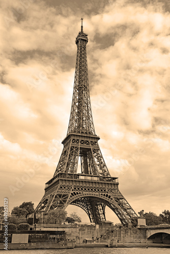 While French elections are making headlines, Eiffel Tower remains popular as ever with tourists, Paris France. Sepia filter