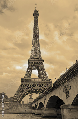 While French elections are making headlines, Eiffel Tower remains popular as ever with tourists, Paris France. Sepia filter
