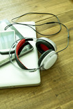 Digital devices and Headphones on a wooden Desktop.