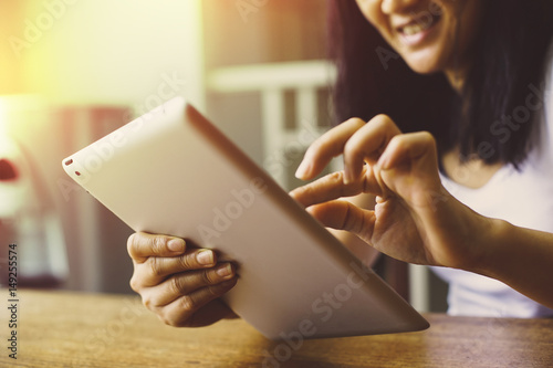 Asian woman using tablet computer . soft Focus on tablet.