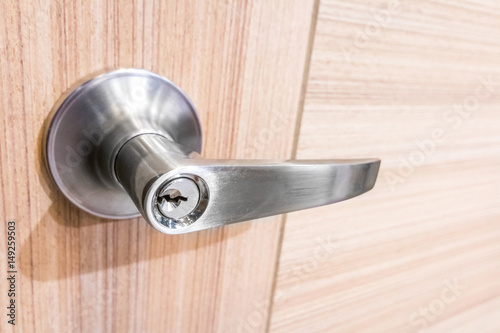 Modern style door handle on natural wooden door