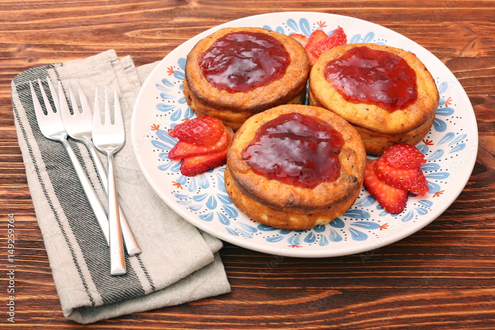 Cottage cheese patties with strawberry jam.