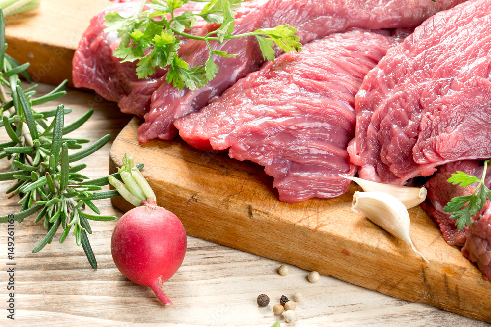 Raw, fresh beef meat with spices, seasoning ready for baking - roasting Raw, fresh beef meat with spices, seasoning ready for baking - roasting