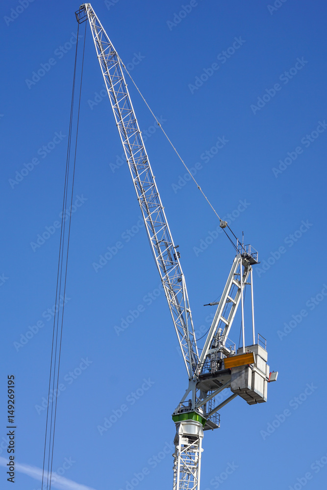 construction tower crane against blue sky